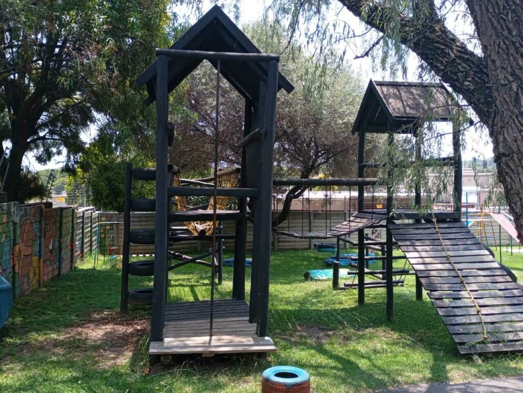 Full view of the wooden jungle gym complex at Petra Christian Pre-School, Edenvale — multi-level timber fort